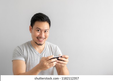 Smile And Happy Face Of Asian Man Play Mobile Game.