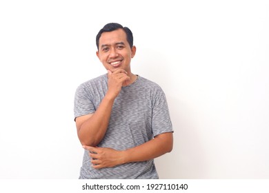 Smile Happy Face Of Ordinary Asian Man In Grey Shirt. Concept Of Charming And Positive Thinking. Isolated On White Background