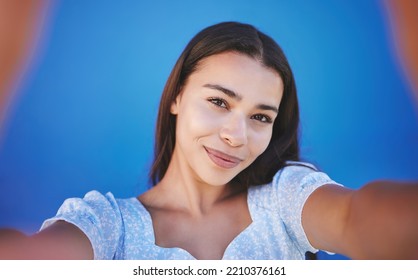 Smile, Happy And Taking Selfie With Woman Showing Face During Travel Against Blue Background. Pov Portrait Of Smiling Female With Natural Beauty Taking A Photo And Having Fun For Social Media