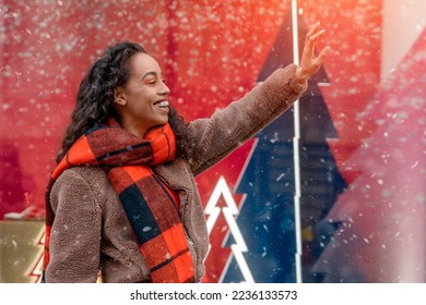Smile happy   woman in a jacket and orange scarf walking outdoors in a celebration city before Christmas,  meeting with friends and looking for presents - Shutterstock ID 2236133573