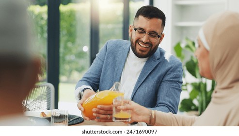 Smile, juice and muslim family in home for breakfast, bonding and healthy dish together. Happy, love and islamic man pour nutrition fruit drink for wife at morning meal in dining room at house. - Powered by Shutterstock