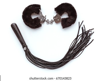 A Smile Made From Sex Toys. Furry Handcuffs And Leather Whip.