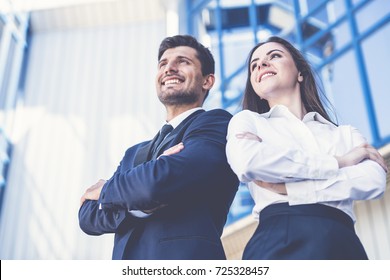 The Smile Man And Woman Stand On The Background Of The Office Center