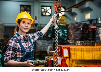 smile milling machine female staff using remote control to adjust chain crane for transport components finished product in professional foundry factory. - Powered by Shutterstock