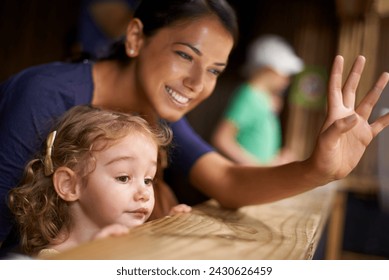 Smile, mother and child at zoo for bonding, love and weekend fun looking at animals from stable. Mom, daughter and family at farm, nature park and cute for outing and holiday getaway with little girl - Powered by Shutterstock