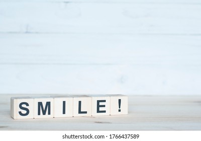 Smile on a wooden cube. Letter constructor