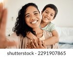 Smile, selfie and mother with child on a bed hug, love and bonding in their home together. Portrait, embrace or woman with son in bedroom waking up, happy and posing for profile picture, photo or pov