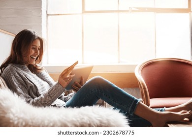 Smile, tablet and credit card with an ecommerce woman on a sofa in the living room of her home. Online shopping, finance and fintech banking with a happy young female online customer in her house - Shutterstock ID 2302678775