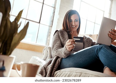 Smile, tablet and credit card, happy woman on couch in living room and internet banking or fintech in home. Technology, online shopping payment and girl on sofa surfing retail website or digital shop - Shutterstock ID 2302678289