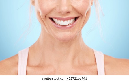 Smile, teeth whitening and woman mouth in studio, blue background and facial wellness. Closeup female model, clean dental and happy face of fresh breath, tooth implant and healthy aesthetic beauty - Shutterstock ID 2272166741