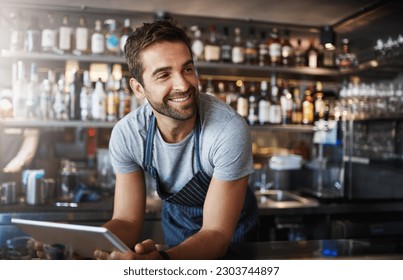 Smile, thinking and a barista with a tablet at a cafe for online orders and communication. Happy, ideas and a male pub manager or bartender with technology for an app, connection and ordering stock - Powered by Shutterstock