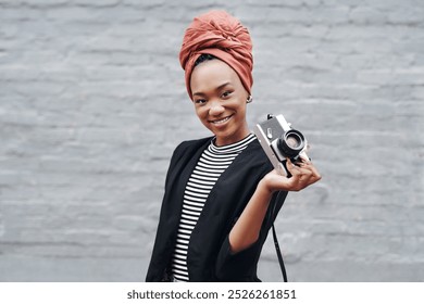 Smile, vintage camera and portrait of black woman with brick wall, confidence and professional artist with pride. Happy creative, photographer or African girl with urban art, opportunity and style - Powered by Shutterstock