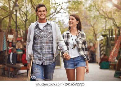 Smile, walking and couple holding hands on city journey, morning trip or weekend tour of urban Spain for outdoor adventure. Love, skateboard and young people bonding together on relax commute - Powered by Shutterstock