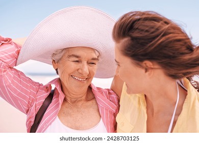 Smile, wind and senior mother on beach with daughter in summer for travel, holiday or vacation. Face, love or bonding with woman and happy elderly parent outdoor together for weekend getaway - Powered by Shutterstock