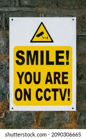 Smile you are on CCTV sign on a brick wall