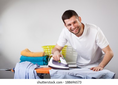 Smiled Househusband Ironing His Shirt By Himself