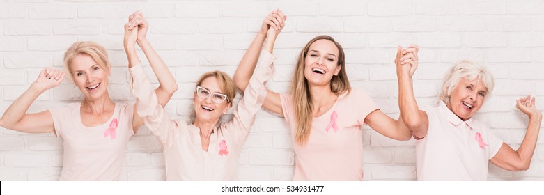 Smiled and strong women are holding each other hands - Shutterstock ID 534931477