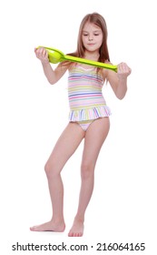 Smiley caucasian little girl wearing swimsuit and holding children paddle isolated over white background