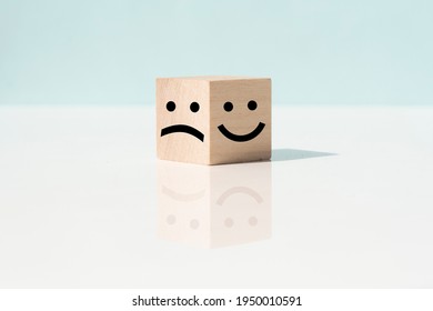 smiley face and sad face icon on wood cube, Service rating, satisfaction concept, copy space.