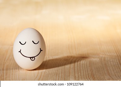 smiley face with tongue on white egg - Powered by Shutterstock