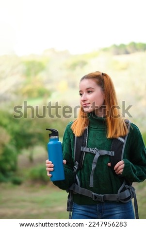 Similar – Image, Stock Photo Redheaded hiker with water bottle on nature getaway