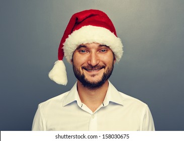 Smiley Man In Santa Claus Hat Over Grey Background