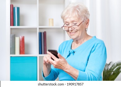 Smiley Senior Woman Texting On Mobile Phone