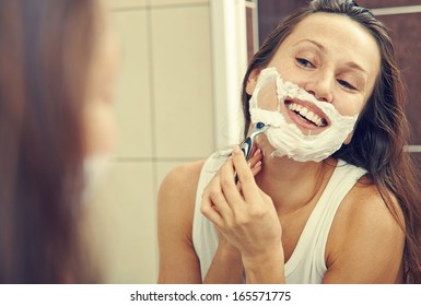 Smiley Woman Looking At Mirror And Shaving Her Face 