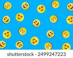 Smileys in the form of gingerbread on the blue background. Flat lay. Pattern.