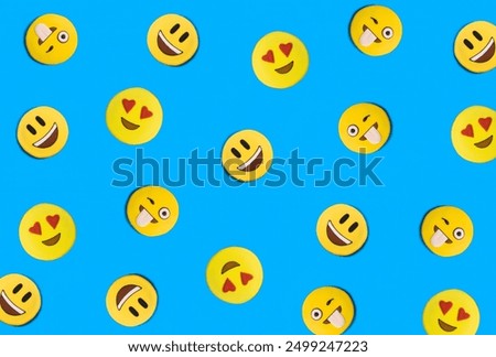 Smileys in the form of gingerbread on the blue background. Flat lay. Pattern.