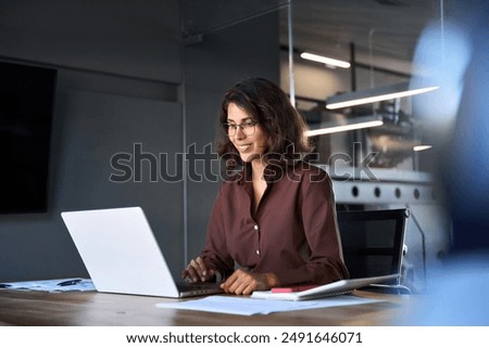 Similar – Image, Stock Photo Smiling mid-adult woman preparing delicious food at home