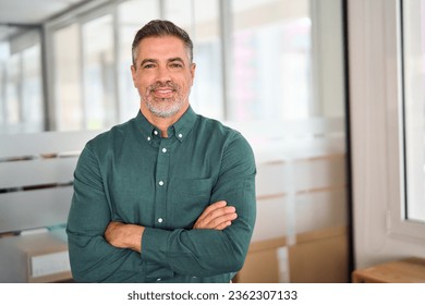 Smiling 40 years old middle aged business man in office, portrait. Confident older bank manager or investor, mid adult businessman boss, successful professional Indian entrepreneur looking at camera.