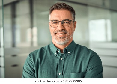 Smiling 45 years old banker, happy middle aged business man bank manager, mid adult professional businessman ceo executive in office, older mature entrepreneur wearing glasses, headshot portrait.