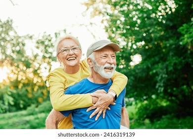 Smiling active senior couple having fun  together in the park, active healthy elderly people bonding, older couple happy relationship - Powered by Shutterstock