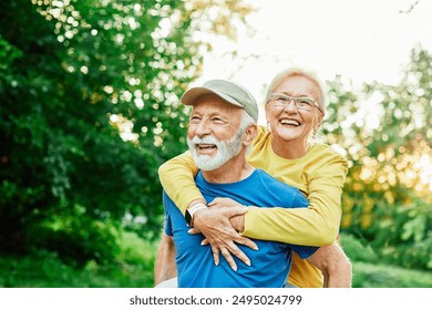 Smiling active senior couple having fun  together in the park, active healthy elderly people bonding, older couple happy relationship - Powered by Shutterstock