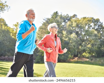 Smiling active senior couple jogging together in the park - Powered by Shutterstock