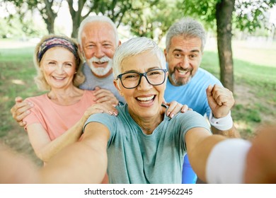 Smiling Active Senior People Posing And Taking Selfie Together In The Park