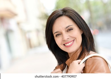 Smiling Active Woman Walking In Street