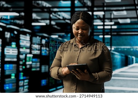 Smiling admin using tablet in data center to track metrics of gear used to host websites. Happy server room IT expert upgrading capacity of storage rackmounts running companies databases