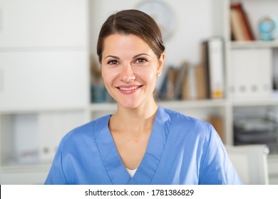 Smiling Adult Doctor Assistant Standing In Medical Office 