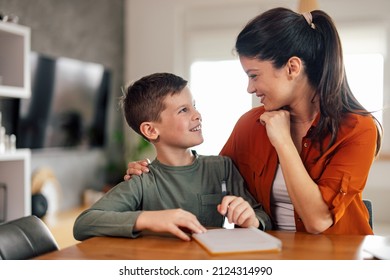 Smiling Adult Woman, Looking At Her Young Son With Glee.