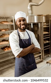 Smiling African American Baker With Crossed Arms On Baking Manufacture