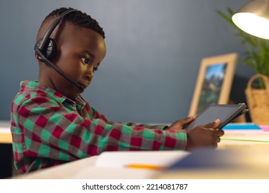 Smiling African American Boy Learning, Using Headphones And Tablet With Copy Space At Home. Home Education, Distance Learning.