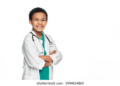 Smiling African American Boy Wearing A Doctor's Coat With Arm Crossed, Posing And Looking At Camera. Child, Future Doctor