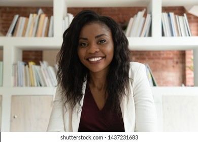 Smiling african american business woman coach teacher hr looking at camera, happy black lady making video call for online job interview by webcamera recording training webinar, webcam view, portrait