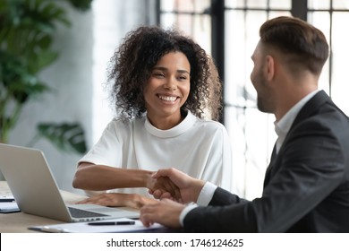 Smiling African American businesswoman advisor broker shaking client customer hand at meeting, making great deal after successful negotiations, executive mentor greeting new worker intern - Shutterstock ID 1746124625