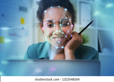 Smiling African American Businesswoman Working With Laptop With Face Recognition Technology In Blurred Office. Toned Image Double Exposure