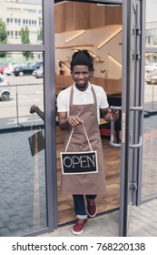 Smiling African American Coffee Shop Owner With Open Sign