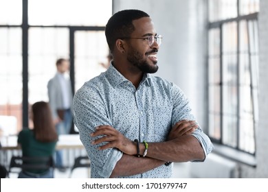 Smiling African American Male Employee Look In Window Distance Planning Future Career Opportunities, Happy Biracial Man Worker Lost In Thoughts Thinking Pondering Of Solution, Business Vision Concept