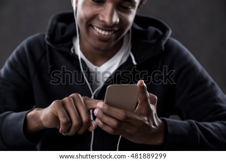 Similar – Attractive black man listening to music with earphones